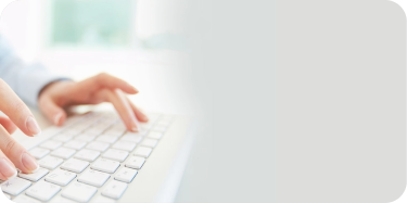 A hand is typing on a keyboard.