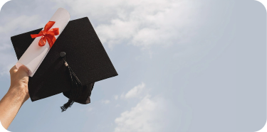 A hand is holding a graduation hat and a degree folded in a ribbon.